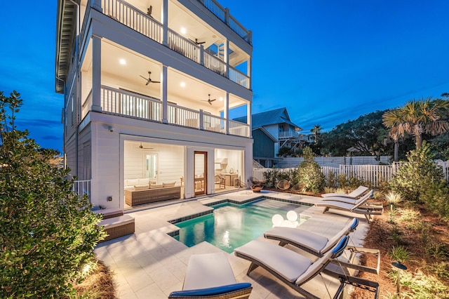 rear view of property with a fenced in pool, a patio, a balcony, and ceiling fan