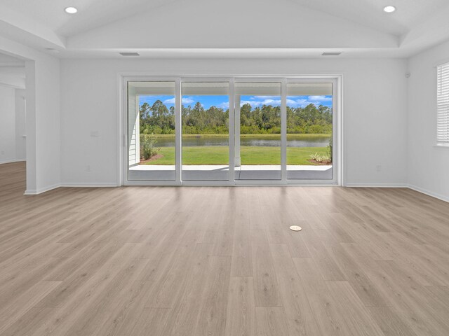 interior space with light wood-type flooring and lofted ceiling