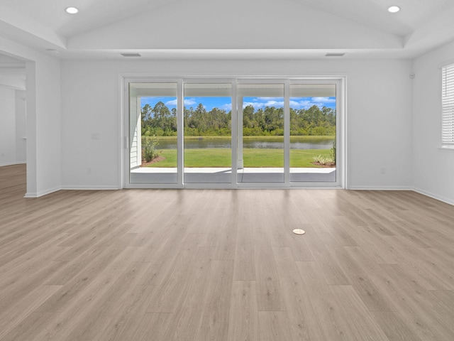 interior space with lofted ceiling, plenty of natural light, and light hardwood / wood-style floors