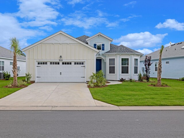 view of front facade featuring a garage, a front lawn, and cooling unit