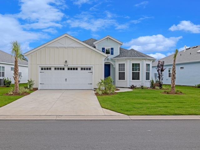 view of front of home featuring a garage, a front lawn, and central air condition unit