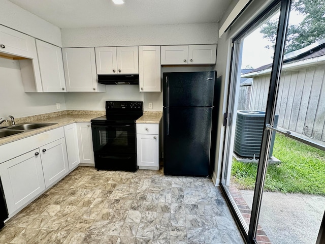 kitchen featuring white cabinetry, black appliances, sink, and light tile patterned floors