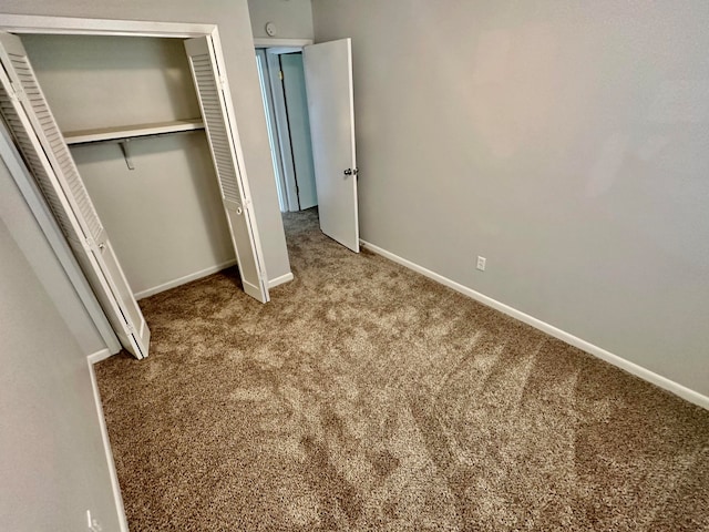 unfurnished bedroom featuring a closet and carpet floors