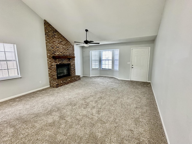 unfurnished living room featuring ceiling fan, carpet floors, a fireplace, baseboards, and vaulted ceiling