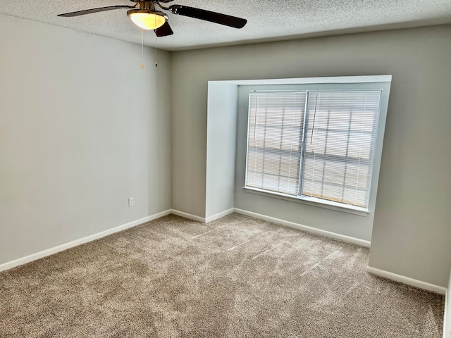 unfurnished room featuring light carpet, ceiling fan, and a textured ceiling