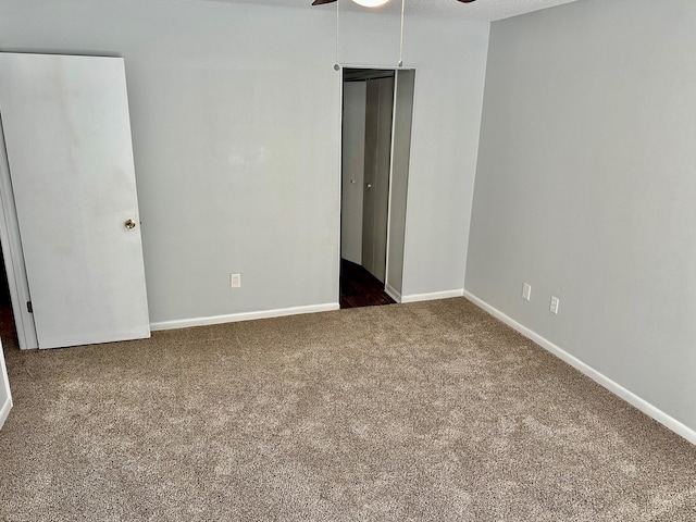 unfurnished bedroom with carpet floors and ceiling fan