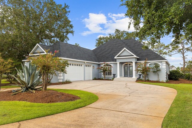 view of front facade with a garage and a front lawn