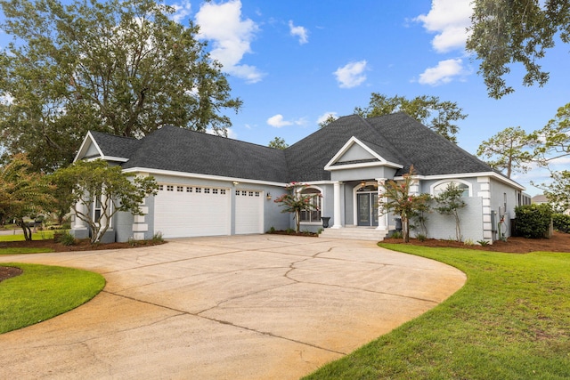1780 Driftwood Point Rd, Santa Rosa Beach, FL 32459 - view of front facade featuring a front yard, an attached garage, a shingled roof, concrete driveway, and brick siding