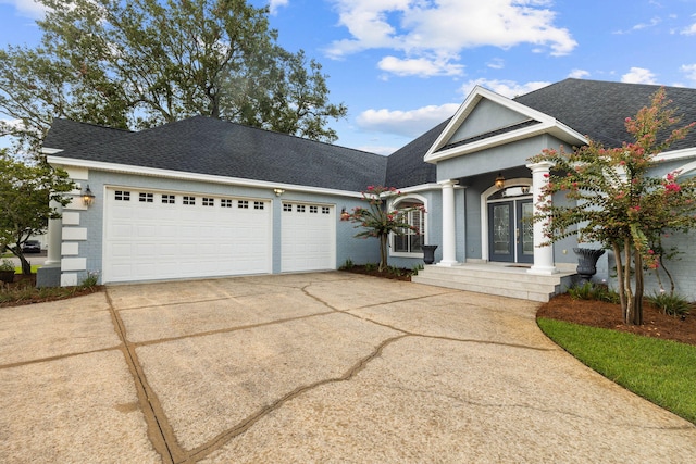 1780 Driftwood Point Rd, Santa Rosa Beach, FL 32459 - neoclassical home with concrete driveway, french doors, a garage, and roof with shingles