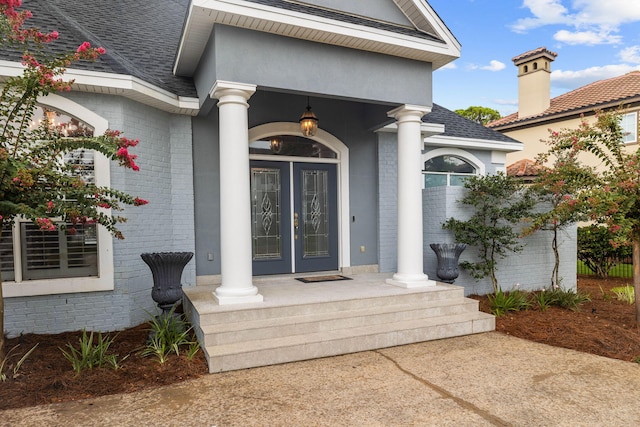1780 Driftwood Point Rd, Santa Rosa Beach, FL 32459 - property entrance featuring brick siding, french doors, and a shingled roof