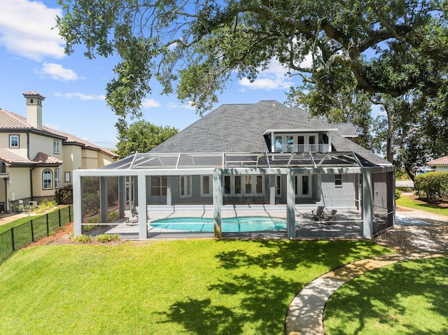 1780 Driftwood Point Rd, Santa Rosa Beach, FL 32459 - rear view of house with glass enclosure, a patio, a balcony, fence, and a lawn