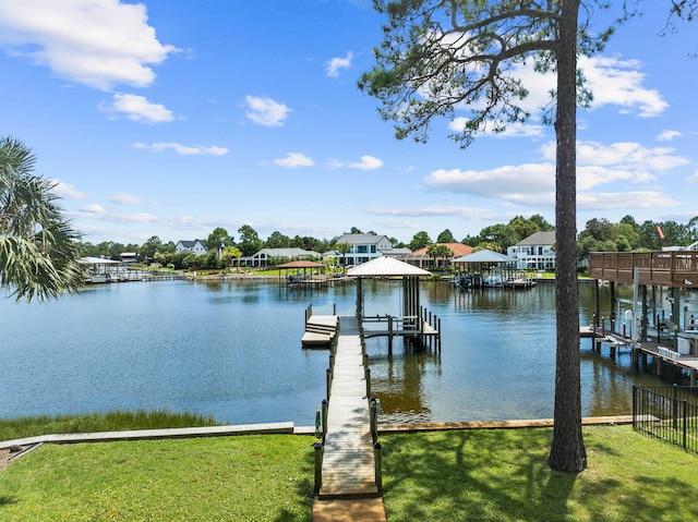 view of dock with a yard and a water view