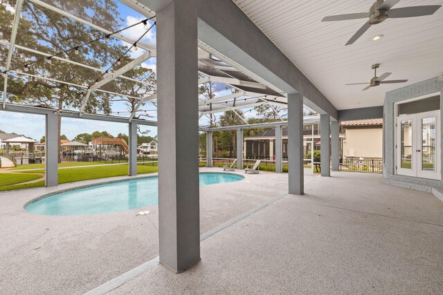 view of swimming pool featuring a lanai, a patio area, ceiling fan, and french doors