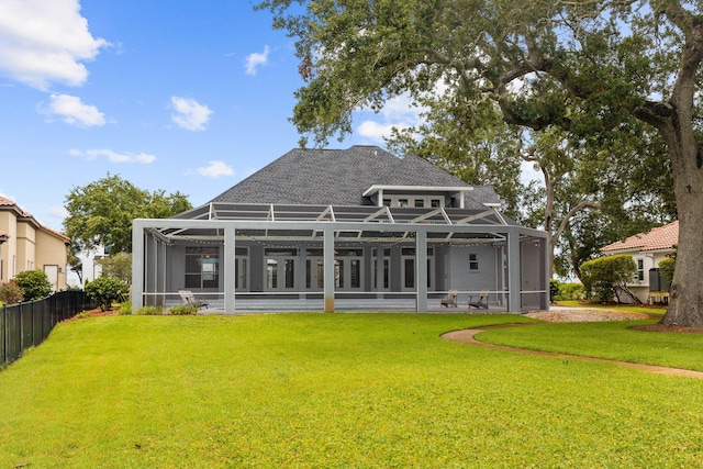 1780 Driftwood Point Rd, Santa Rosa Beach, FL 32459 - rear view of house featuring glass enclosure, a lawn, roof with shingles, and fence
