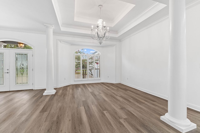 1780 Driftwood Point Rd, Santa Rosa Beach, FL 32459 - unfurnished dining area featuring a chandelier, ornamental molding, wood finished floors, a raised ceiling, and ornate columns