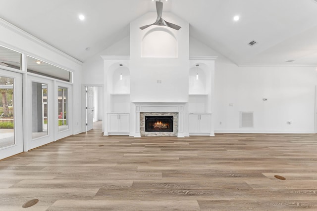 1780 Driftwood Point Rd, Santa Rosa Beach, FL 32459 - unfurnished living room featuring visible vents, high vaulted ceiling, a stone fireplace, and light wood-style floors