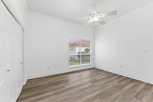 unfurnished bedroom with ceiling fan, a closet, crown molding, and wood-type flooring