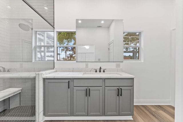1780 Driftwood Point Rd, Santa Rosa Beach, FL 32459 - full bath with vanity, wood finished floors, visible vents, baseboards, and a tile shower