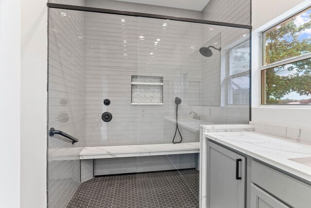 bathroom with tile patterned flooring, vanity, and a shower with shower door