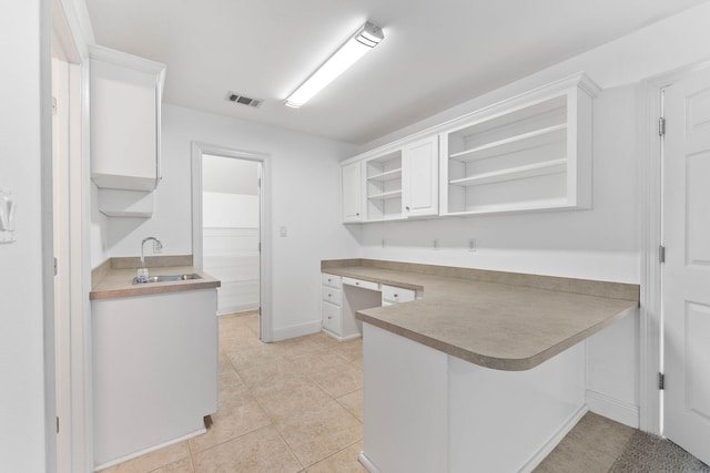 1780 Driftwood Point Rd, Santa Rosa Beach, FL 32459 - kitchen with open shelves, white cabinetry, and a sink