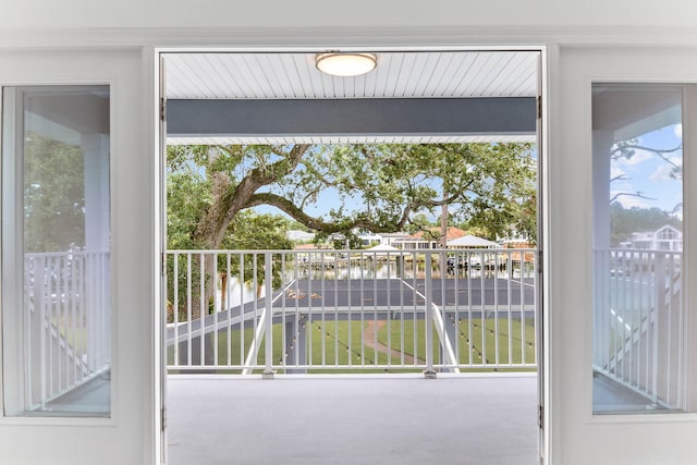 doorway with a water view and carpet