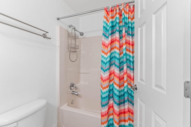 bathroom with shower / bath combo and toilet