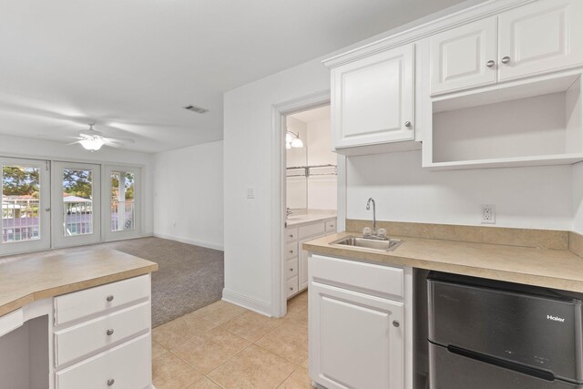 kitchen with white cabinetry, french doors, ceiling fan, sink, and refrigerator