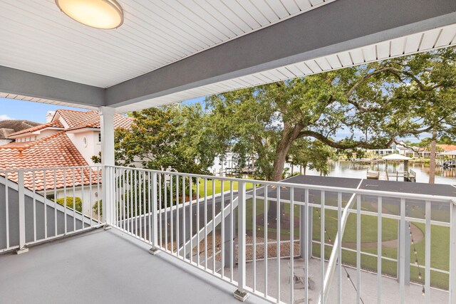 balcony featuring a water view and a dock