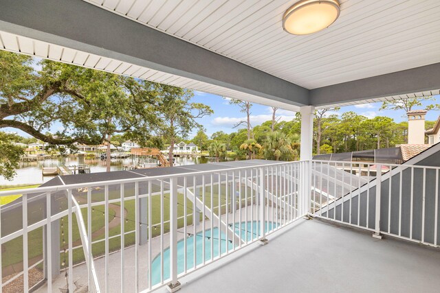 balcony with a water view and a patio