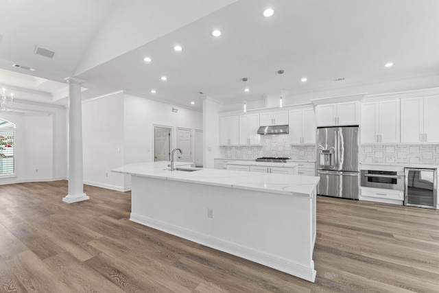 1780 Driftwood Point Rd, Santa Rosa Beach, FL 32459 - kitchen with under cabinet range hood, a sink, stainless steel appliances, wine cooler, and ornate columns