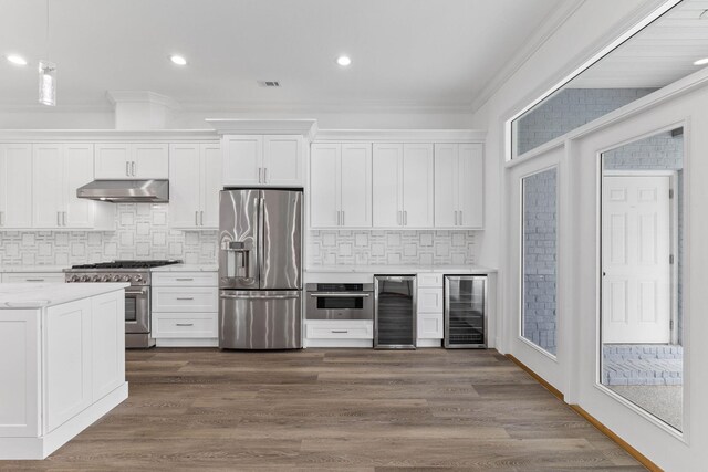 kitchen featuring white cabinets, stainless steel appliances, wine cooler, and tasteful backsplash