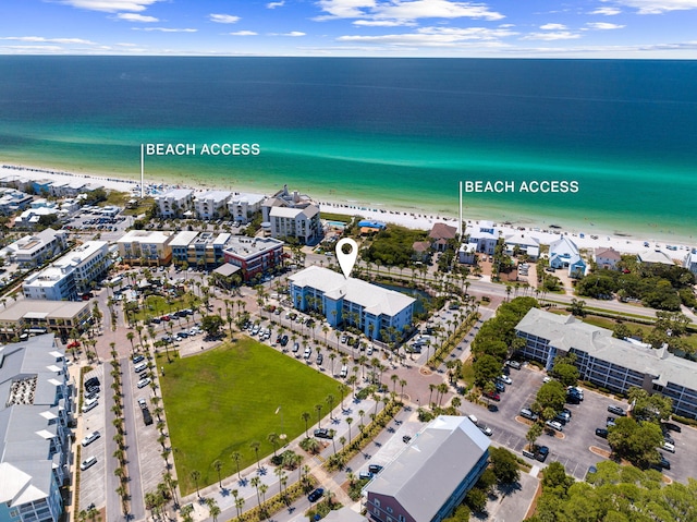 aerial view with a water view and a beach view