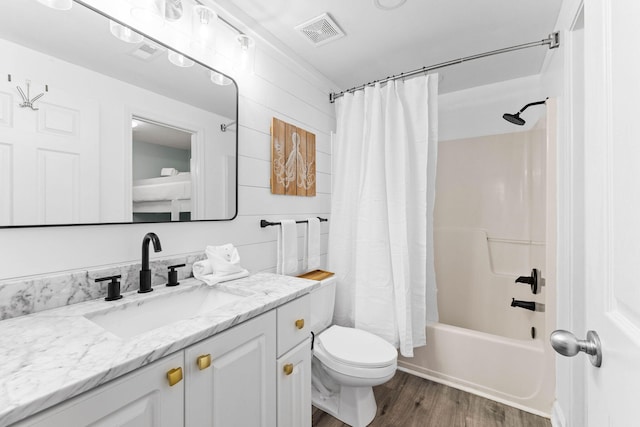 full bathroom with hardwood / wood-style floors, shower / bath combo, toilet, and vanity