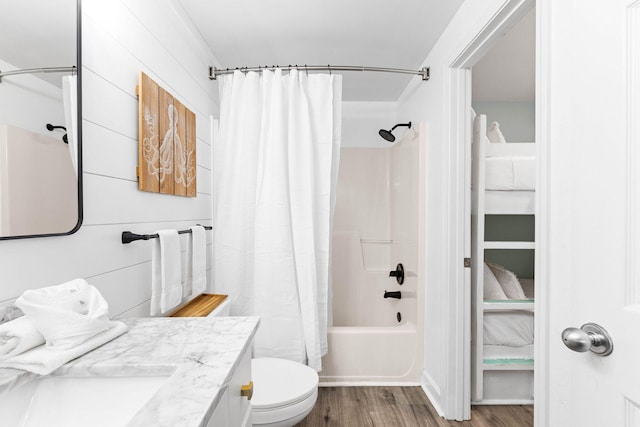 full bathroom featuring vanity, toilet, wood-type flooring, and shower / tub combo