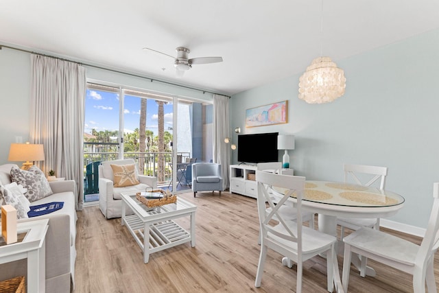 living room with light hardwood / wood-style floors and ceiling fan