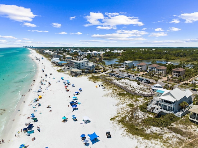 drone / aerial view featuring a water view and a beach view