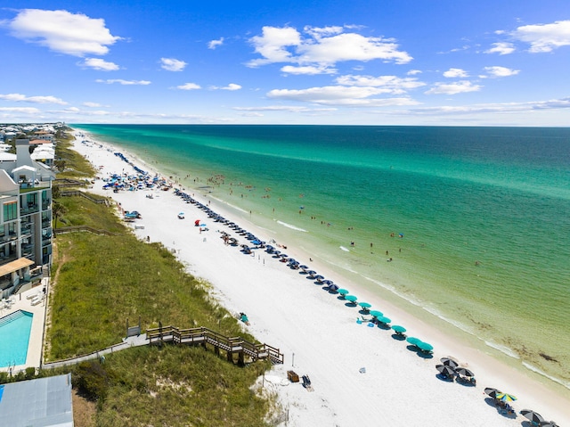 bird's eye view featuring a view of the beach and a water view