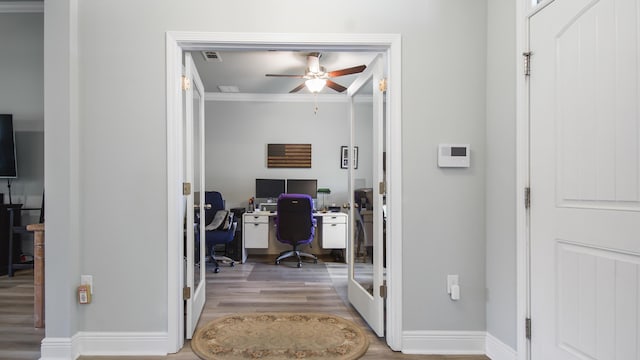 office with hardwood / wood-style flooring, ceiling fan, and ornamental molding