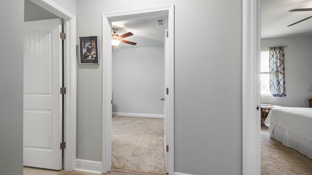 hallway with light colored carpet