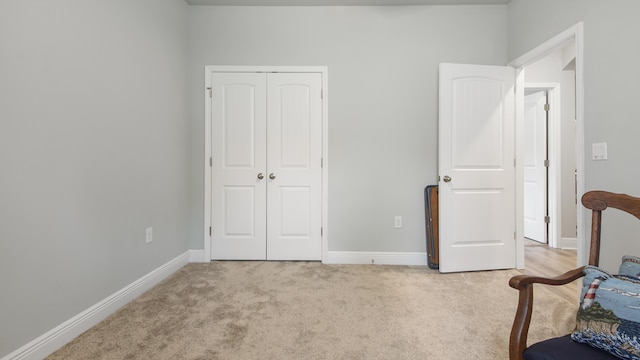 bedroom with light colored carpet and a closet