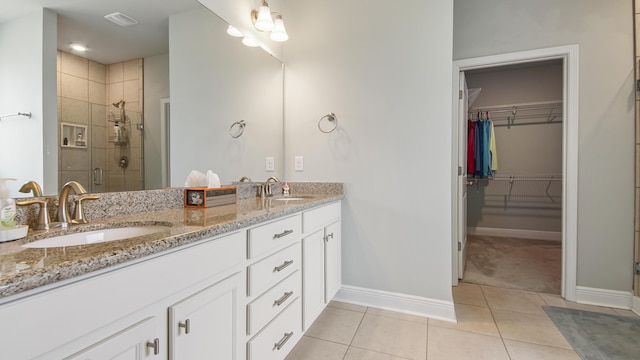 bathroom with tile patterned flooring, an enclosed shower, and vanity