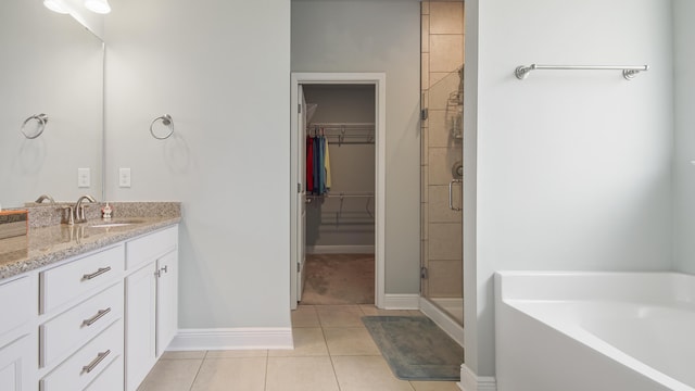 bathroom with independent shower and bath, vanity, and tile patterned floors