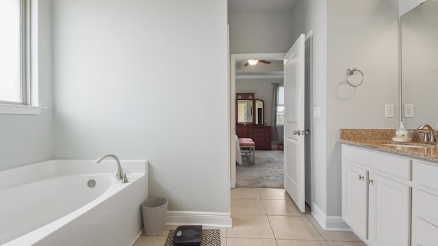 bathroom with vanity, plenty of natural light, tile patterned floors, and a bathtub