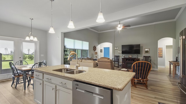 kitchen with sink, dishwasher, white cabinetry, hanging light fixtures, and a center island with sink