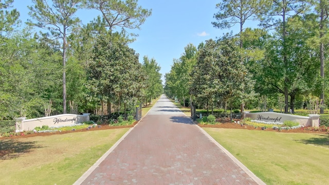 view of property's community with a lawn