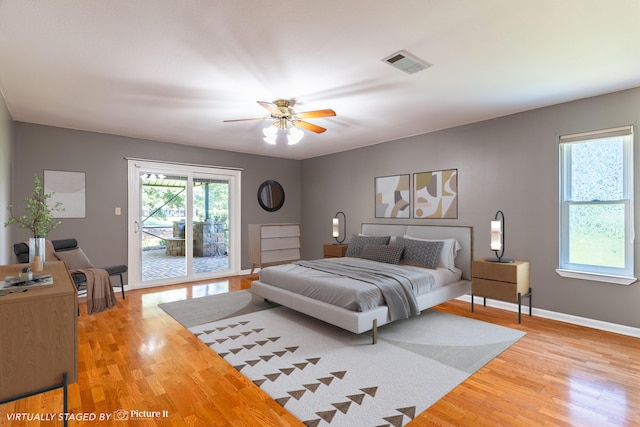 bedroom with ceiling fan, light hardwood / wood-style floors, and access to exterior