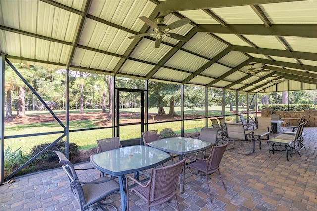 sunroom featuring ceiling fan and vaulted ceiling