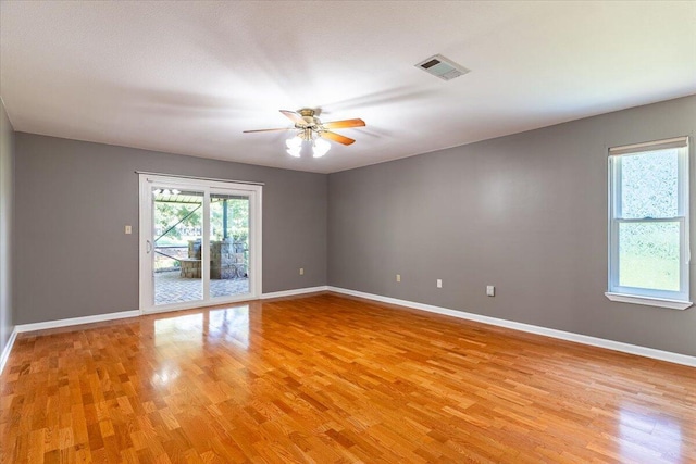 empty room with ceiling fan and light wood-type flooring