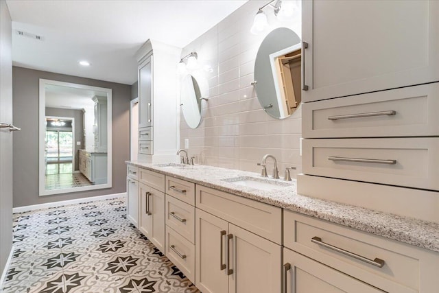 bathroom featuring vanity and decorative backsplash