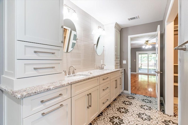 bathroom featuring tile patterned floors, vanity, and ceiling fan